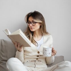 medium-shot-woman-reading-home